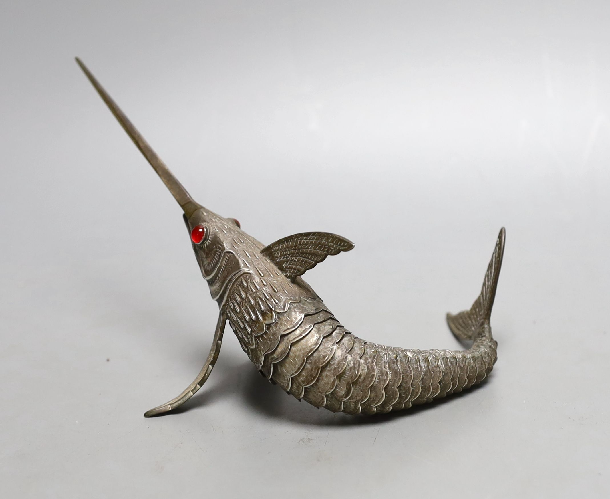 A 20th century Spanish articulated model of a swordfish, with red glass eyes, approx. 26.5cm, gross weight 118 grams.